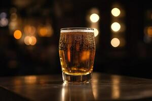 Glass of beer on a table in a bar on blurred bokeh background photo