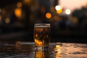 Glass of beer on a table in a bar on blurred bokeh background photo