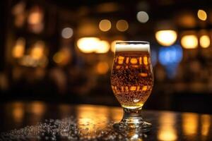 Glass of beer on a table in a bar on blurred bokeh background photo