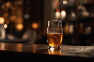 Glass of beer on a table in a bar on blurred bokeh background photo