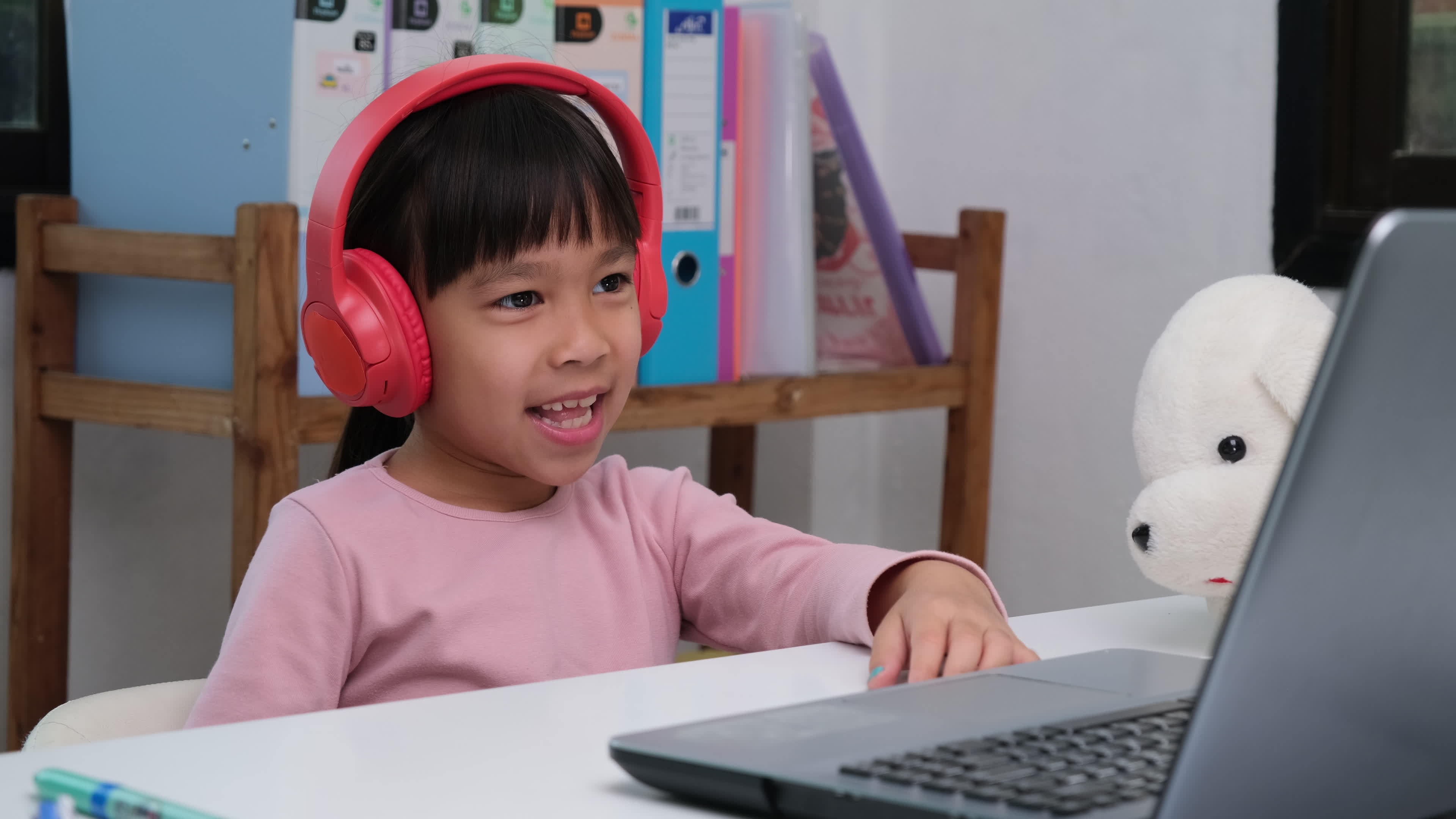 Young girl playing video games on computer after online school and  homework. Gamer using shooting action play for entertainment and fun with  keyboard and monitor. Child enjoying game Stock Photo - Alamy