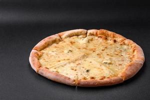 Delicious fresh hot pizza four cheeses cut into pieces photo