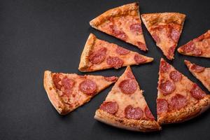 Delicious fresh pepperoni pizza with sesame seeds on the sides photo