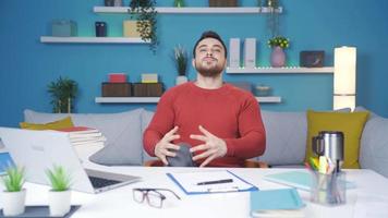 Young man showing how to exercise in the office. doing leg exercises. Man working from home showing how to do leg exercise against camera. video