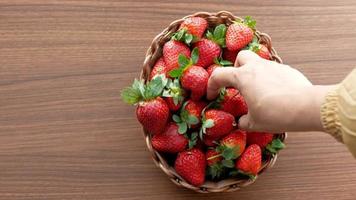 Ripe Red Strawberries in a bowl on table . video