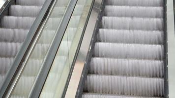 Close-up shot of empty moving staircase running up and down. Modern escalator stairs video