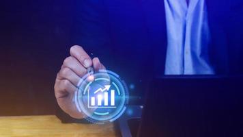 Big data analytics and business intelligence BI concept with chart and graph icons on digital screen interface and business people in the background. photo