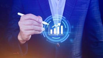 Big data analytics and business intelligence BI concept with chart and graph icons on digital screen interface and business people in the background. photo