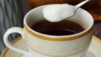 putting white sugar in tea cup video