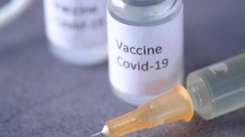 Close up of coronavirus vaccine and syringe video
