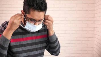 young man wearing protective mask close up video