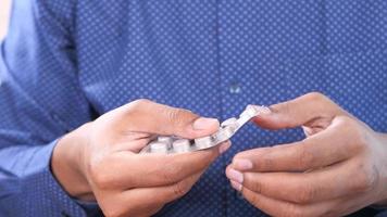 Close up of man hand taking medicine . video