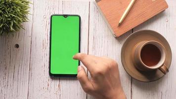 top view of man hand using smart phone on office desk video