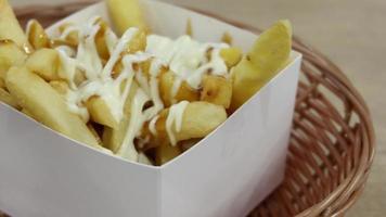 Close up French Fries topped with mayonnaise video