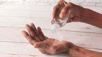 Close up of senior woman hand using sanitizer gel for preventing virus video