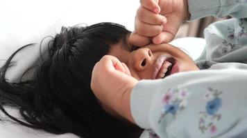 baby girl crying while laying on her back close up video