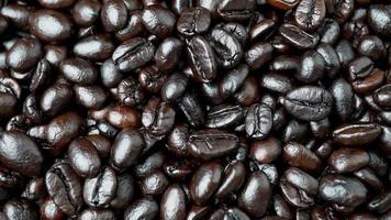 Close up rotating of group black coffee beans. Strong black espresso, Grains of coffee background, texture video