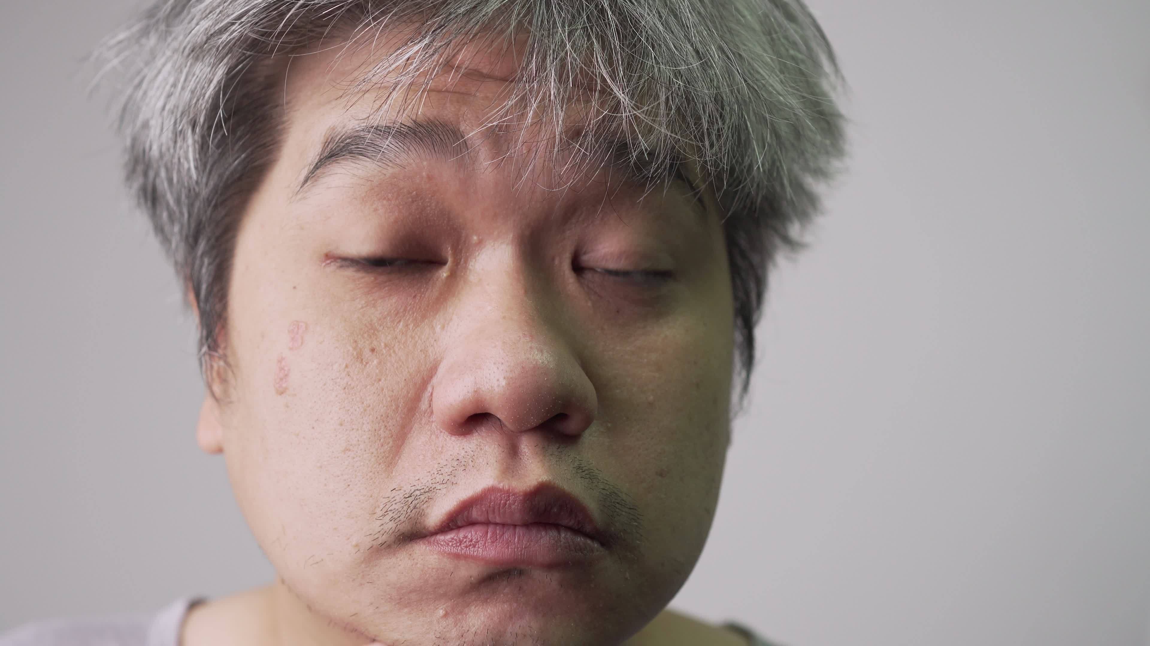 Elderly Asian Man Checks Facial Skin In The Mirror Concept Of elderly-asian-man-checks-facial-skin-in-the-mirror-concept-of