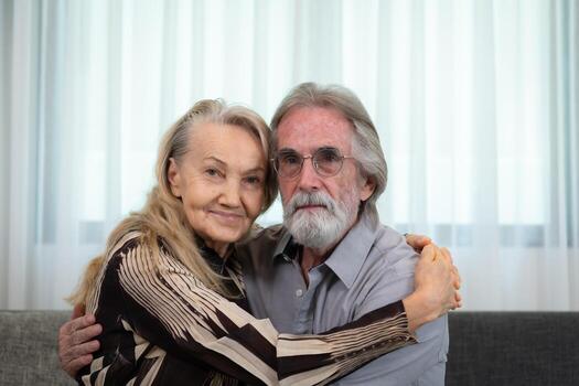 A long-term relationship that lasts till old age, characterized by unwavering affection. Still expressing affection and joyfully hugging one another. photo