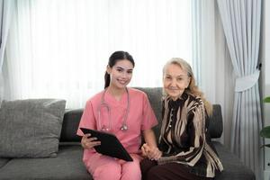 Caregiver for an elderly woman Weekly check-ups at the patient's residence. Ready to give medical advice and talk about various stories, exchange each other happily. photo