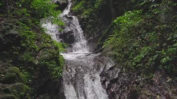 Footage of small water fall on tropical forest. Water flowing through river stone. The footage is suitable to use for nature footage, and travel destination footage. video