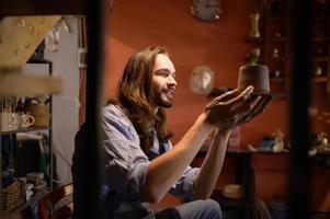 Pottery artist, Young making a piece of clay molding calmly and meticulously In order to produce the most attractive work possible, photo