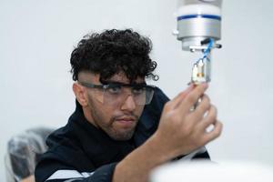 Students studying robotic hand technology are learning how to construct robotic hands for a range of industrial uses. photo