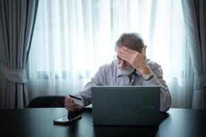 An elderly man experiencing financial difficulties. due to lack of saving during working age and no children to support photo