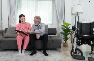 Caregiver for an elderly man Weekly check-ups at the patient's residence. Ready to give medical advice and talk about various stories, exchange each other happily. photo