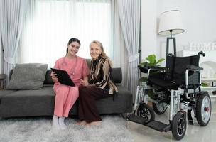 Caregiver for an elderly woman Weekly check-ups at the patient's residence. Ready to give medical advice and talk about various stories, exchange each other happily. photo