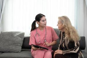 Caregiver for an elderly woman Weekly check-ups at the patient's residence. Ready to give medical advice and talk about various stories, exchange each other happily. photo