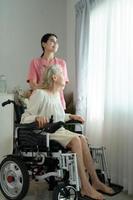 Caregiver for an elderly woman Weekly check-ups at the patient's residence. Ready to give medical advice and talk about various stories, exchange each other happily. photo