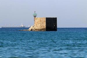 A lighthouse is a navigational landmark that is used to identify coasts and locate ships. photo