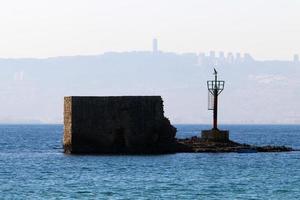 A lighthouse is a navigational landmark that is used to identify coasts and locate ships. photo