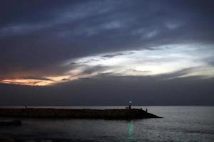 A lighthouse is a navigational landmark that is used to identify coasts and locate ships. photo