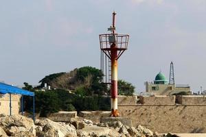 A lighthouse is a navigational landmark that is used to identify coasts and locate ships. photo