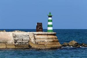 A lighthouse is a navigational landmark that is used to identify coasts and locate ships. photo