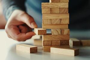 close up of hand businessman playing block wood photo