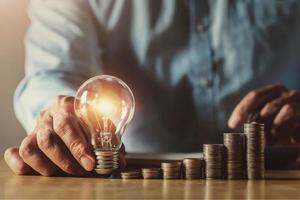 businessman hand holding light bulb. idea concept with innovation and inspiration. idea finance accounting photo