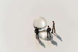 business miniature toy with globe glass on white background photo