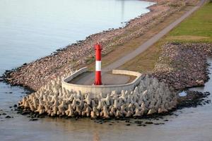 A lighthouse is a navigational landmark that is used to identify coasts and locate ships. photo