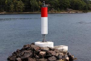 A lighthouse is a navigational landmark that is used to identify coasts and locate ships. photo