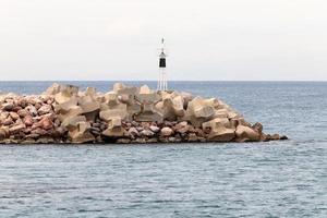 A lighthouse is a navigational landmark that is used to identify coasts and locate ships. photo
