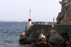 A lighthouse is a navigational landmark that is used to identify coasts and locate ships. photo