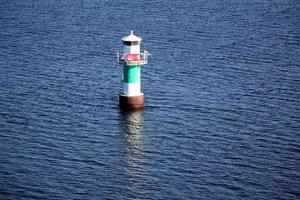 A lighthouse is a navigational landmark that is used to identify coasts and locate ships. photo