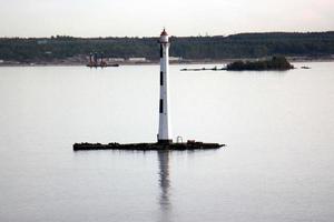 A lighthouse is a navigational landmark that is used to identify coasts and locate ships. photo