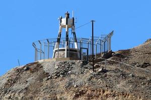 A lighthouse is a navigational landmark that is used to identify coasts and locate ships. photo