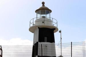 A lighthouse is a navigational landmark that is used to identify coasts and locate ships. photo