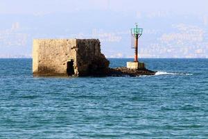 A lighthouse is a navigational landmark that is used to identify coasts and locate ships. photo