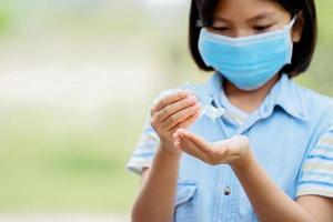 woman using alcohol gel from bottle and applying sanitizer for hand make cleaning virus covid 19 photo